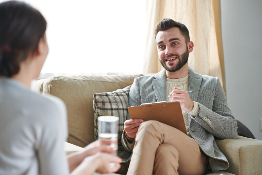 Therapist talking to a patient sitting on the couch