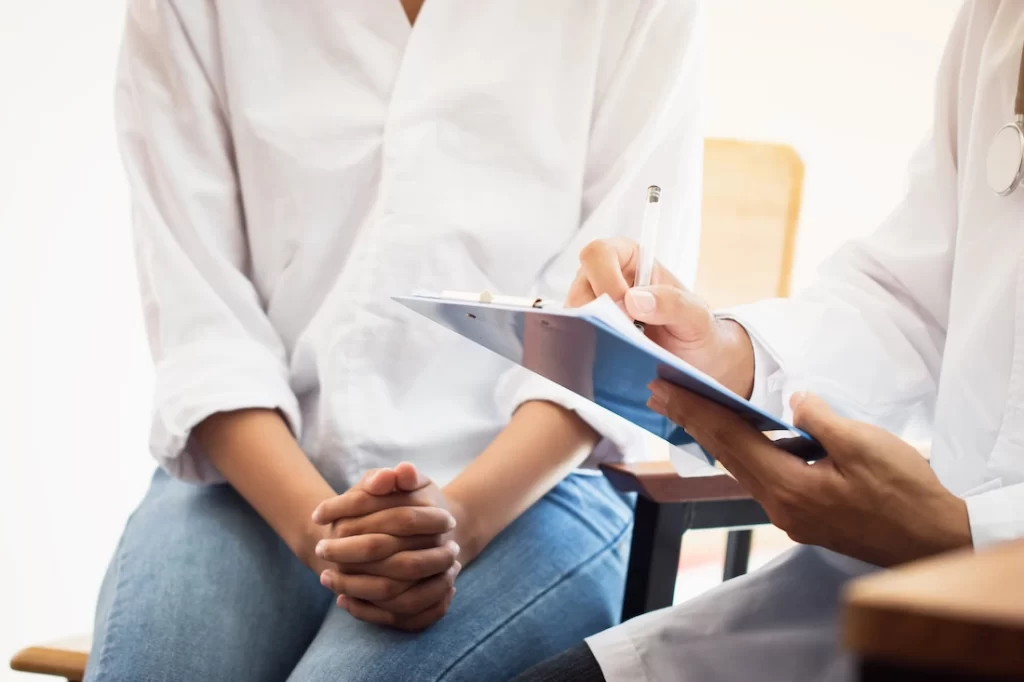 A person talks to their provider about whole person treatment.