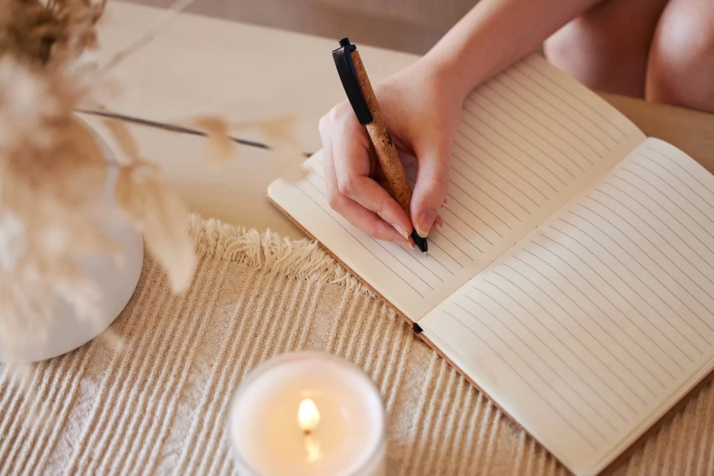 A person journals about addiction recovery.