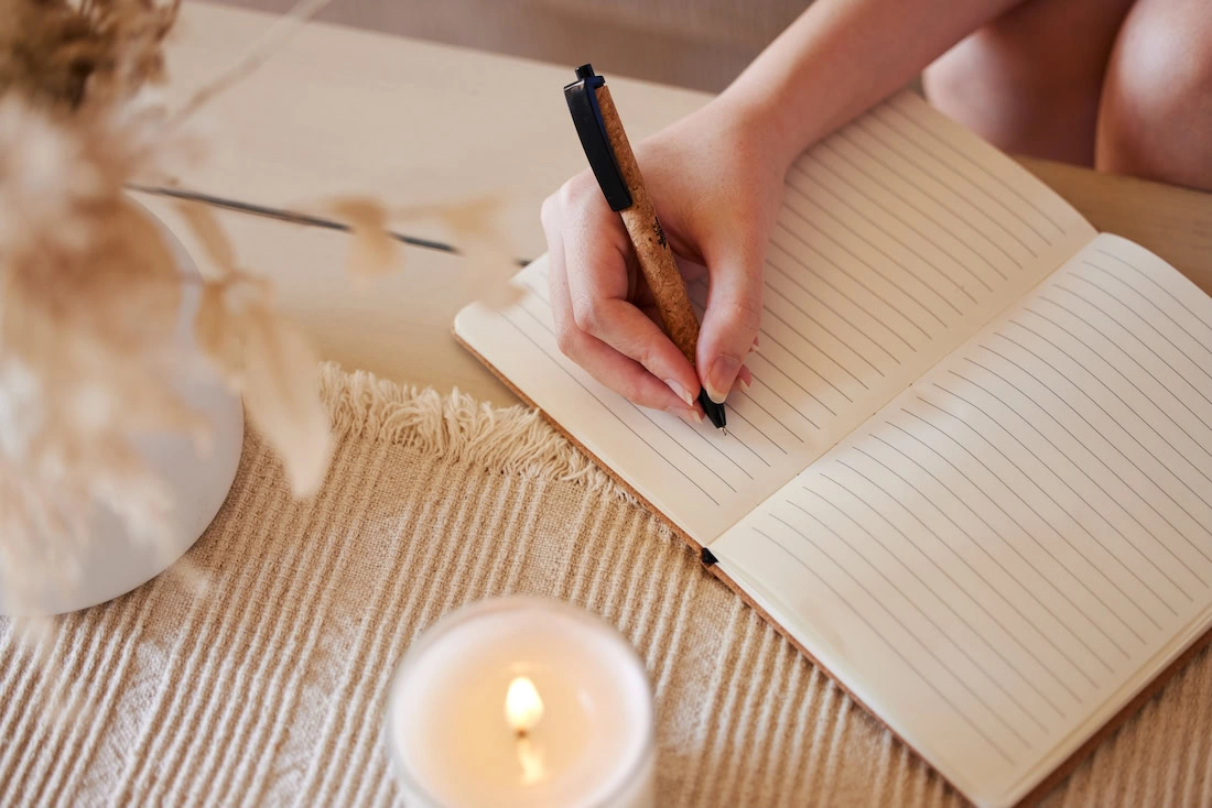 A person journals about addiction recovery.