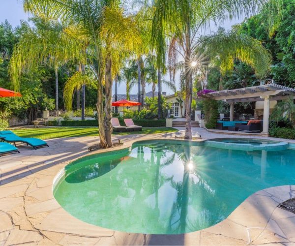 4 seasons detox recovery center pool and backyard with covered seating and an outdoor fireplace